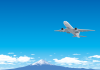 富士山をバックに飛行するジェット旅客機