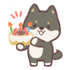 誕生日ケーキを持つ黒柴犬