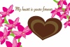 ハート型のチョコレートとピンクの蘭の花のメッセージカード