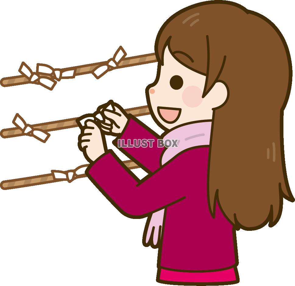 おみくじを結ぶ女性