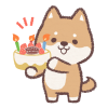 誕生日ケーキを持つ柴犬